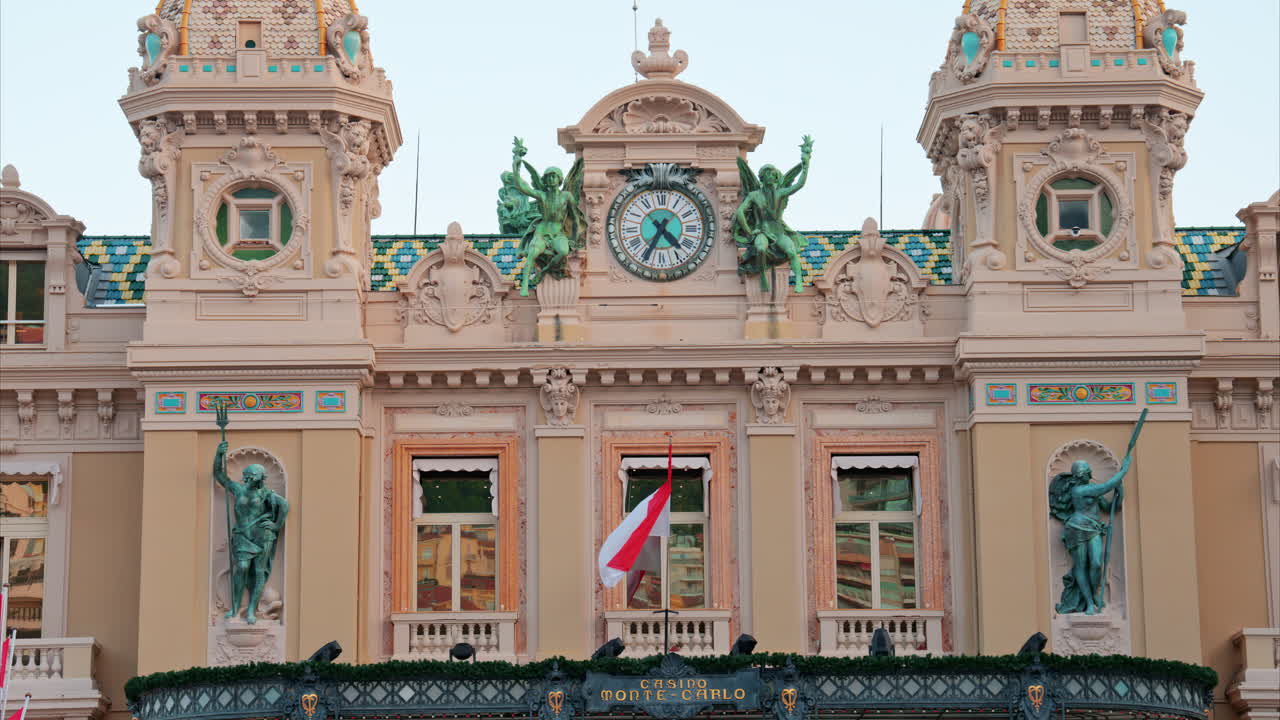 Monte Carlo, Monaco - October 24, 2024: The coat of arms of Monaco and multiple flags waving in front of the Monte Carlo Casino
