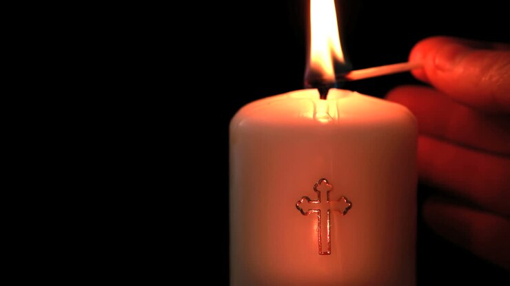 Candle with cross embellishment
