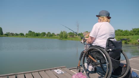 man with disabilities fishing at a lake. wheelchair. camping. summertime