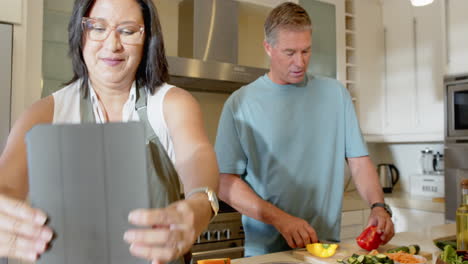 preparing fresh vegetables, senior diverse couple cooking together in modern kitchen, at home