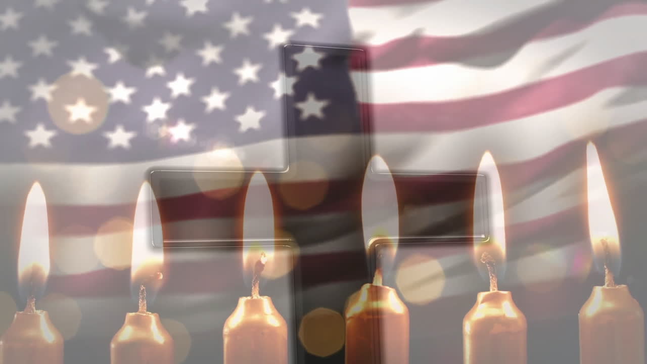 Burning candles in front of American flag and cross, symbolizing remembrance