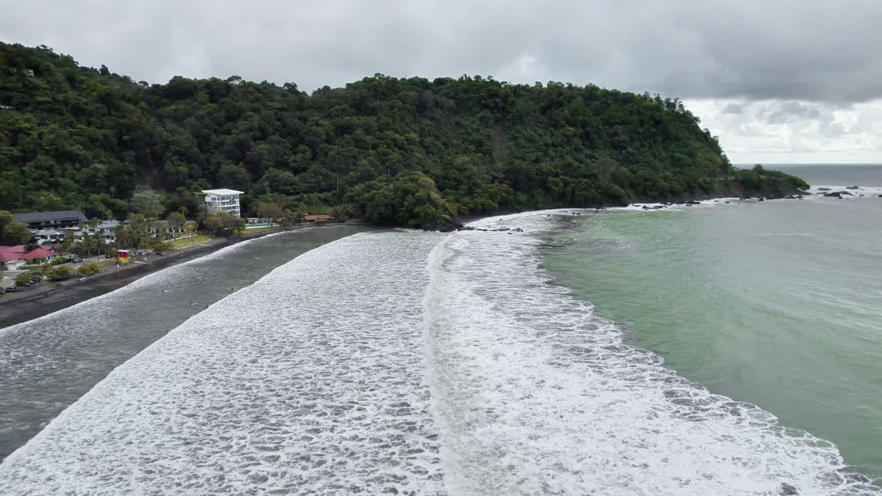 Panorama view of waves rolling onto shore in Playa Hermosa, Puntarenas