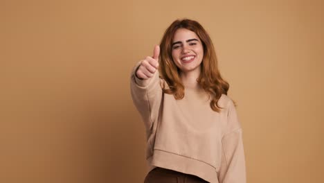 happy young woman showing thumb up gesture