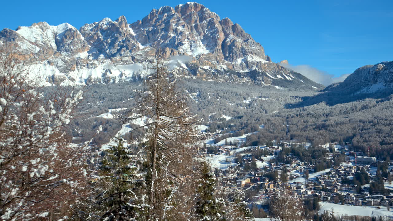 Aerial drone view of the houses in the village covered in snow, in South Tyrol, the Dolomites