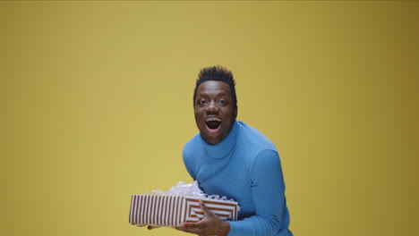 man reacts to receiving a gift box