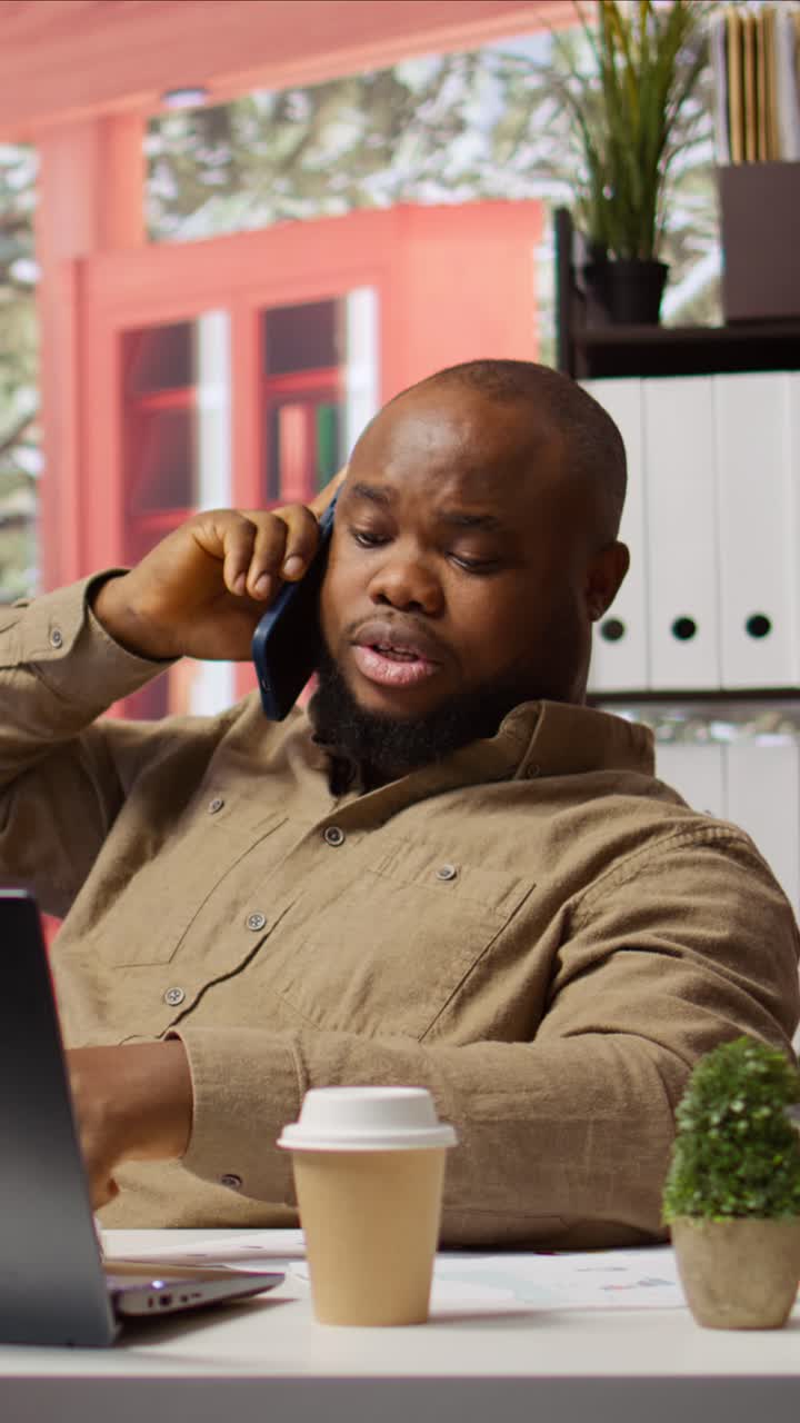 Cheerful African American Man Talking on Smartphone in Office