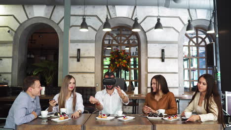 Team-of-developers-working-with-virtual-reality-glasses-during-a-business-meeting.-Young-business-colleagues-brainstorming-using-VR-goggles