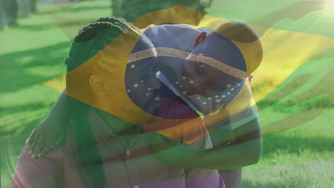 animation of flag of brazil over african american father with son