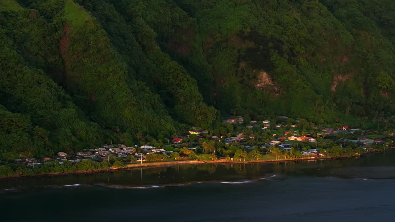Sunrise over a Coastal Village Nestled in Lush Green Mountains