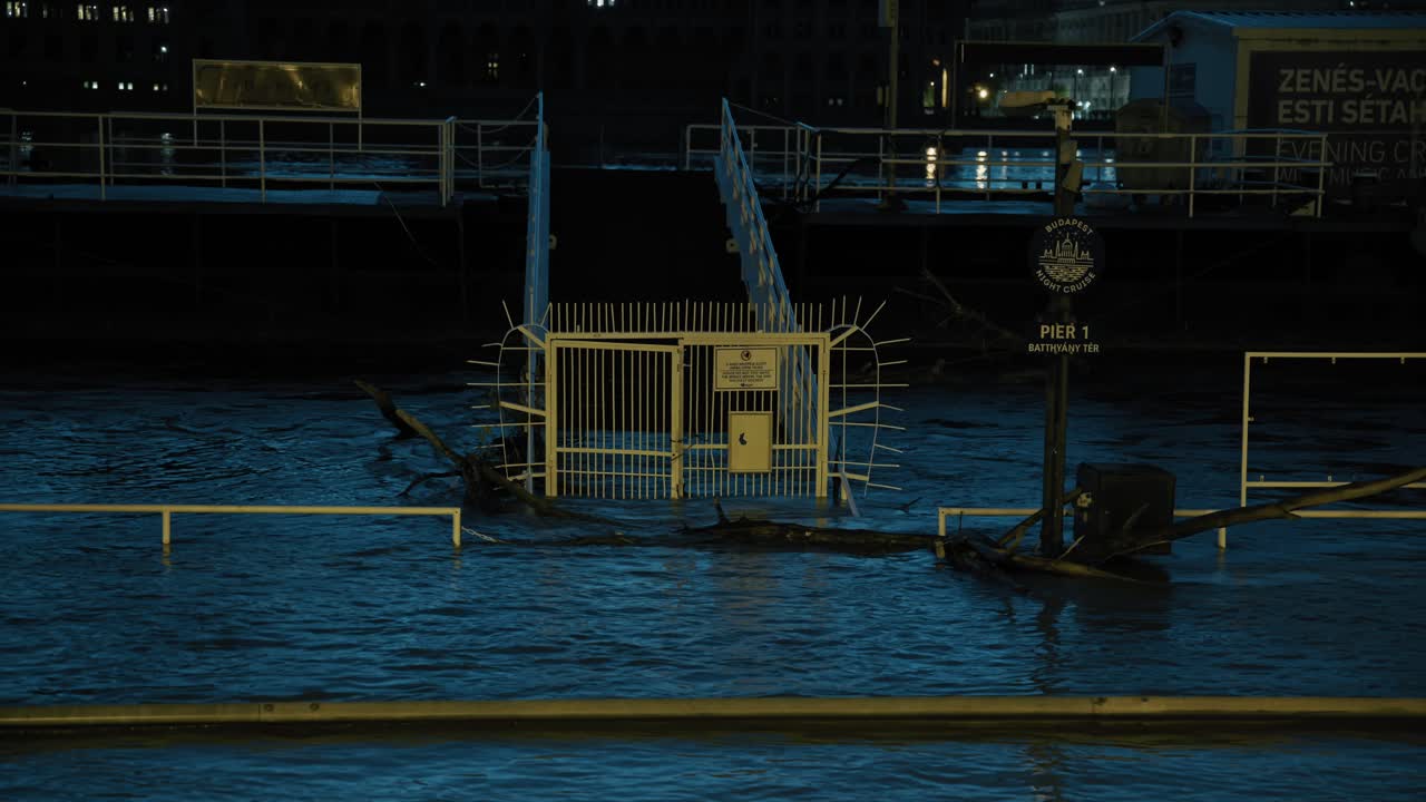 Flooded Budapest pier at night, submerged gate during 2024 Hungary flood