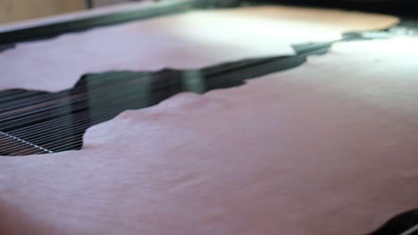 leather placed on electronic measuring machine in a tannery in ethiopia, africa. - closeup shot