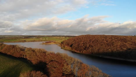 aerial panning left shot of wimbleball lake exmoor england on a beautiful autumn evening