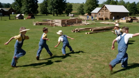children playing and jumping on a farm during a barn raising event