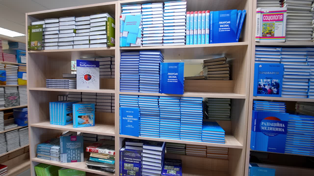 Books on shelves in ibrary. Interior view of long room of the library