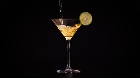 drink being poured into a cocktail glass