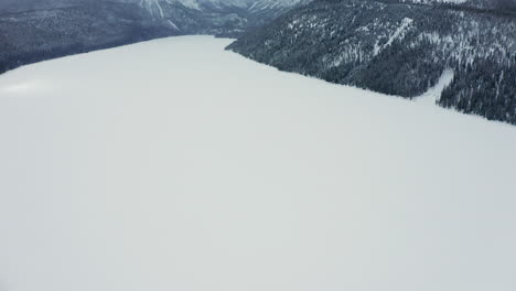 panning up over frozen redfish lake to sawtooth mountains idaho in winter