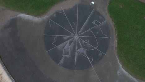 Aerial upward shot of a cemented circular area on a street of Scarborough bay with some people during a winter evening in North Yorkshire, England