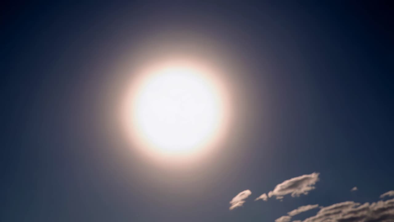 A video captures a solar eclipse from a low-angle perspective, highlighting the crescent sun