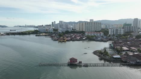 pan across cityscape skyline, modern george town on coast of malaysia