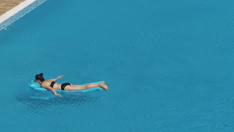 woman swimming on a blue water pool