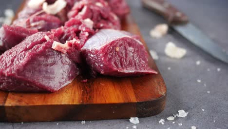 raw beef cuts on a wooden cutting board