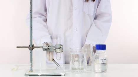 scientist conducts copper carbonate decomposition in laboratory