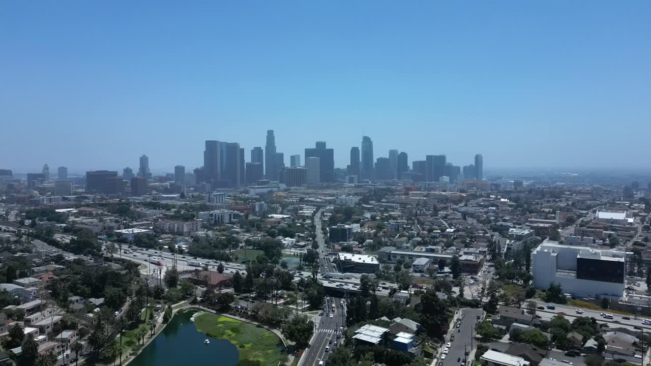 Cinematic 4K drone shot flying forward toward the Los Angeles skyline during daytime. Slow motion capable, perfect for urban, travel, lifestyle, or cinematic projects