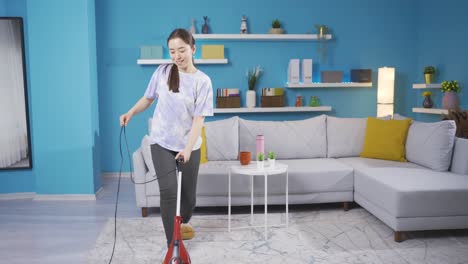young woman cleaning the house sits on the sofa and rests.