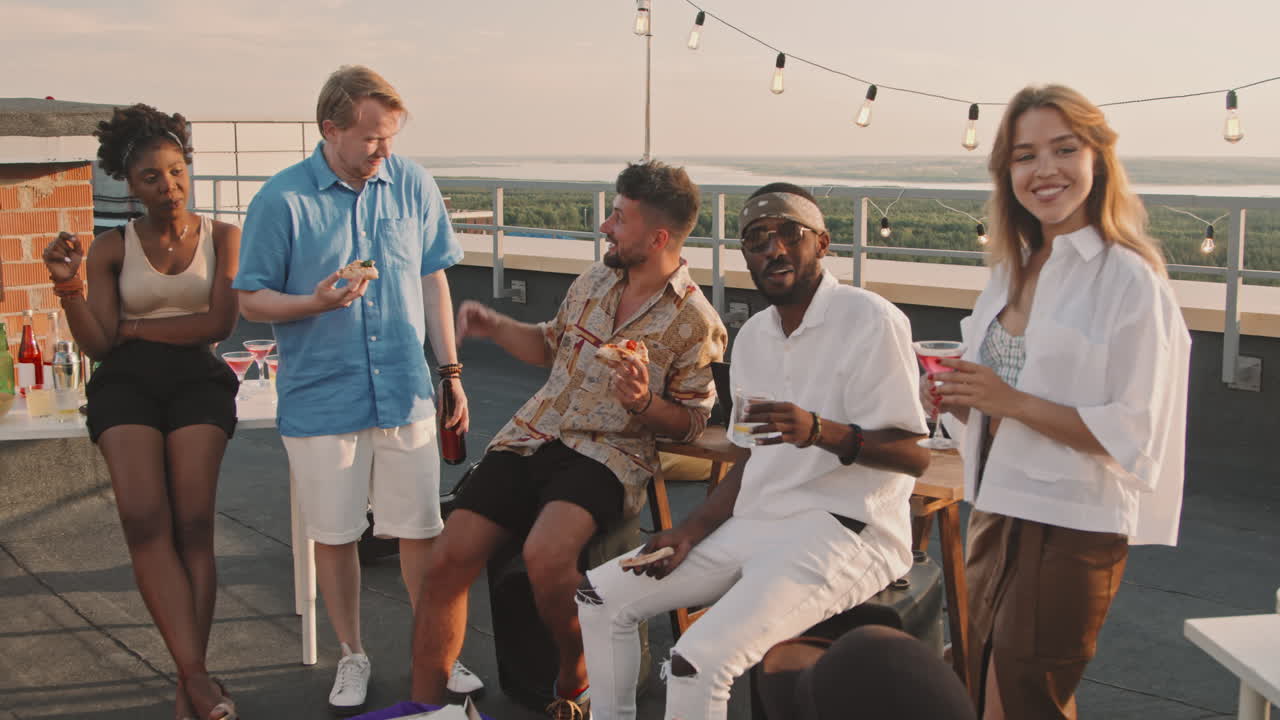 Happy People Chatting and Hanging Out on Rooftop Terrace