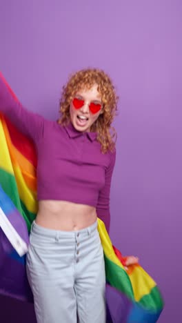 woman celebrating pride with rainbow flag