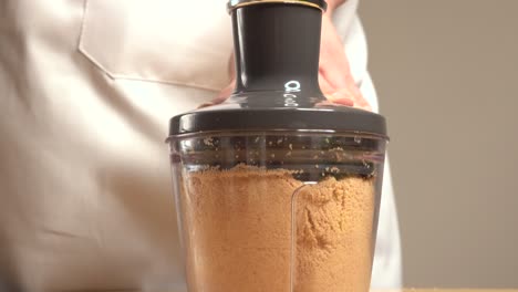 woman handling mixer running with cookie dough to make cakes