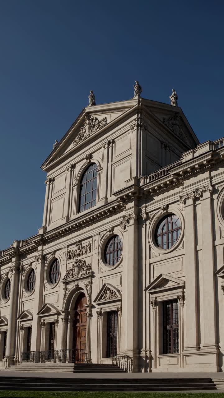 Low-angle video frame of a grand neoclassical building, capturing intricate architectural details