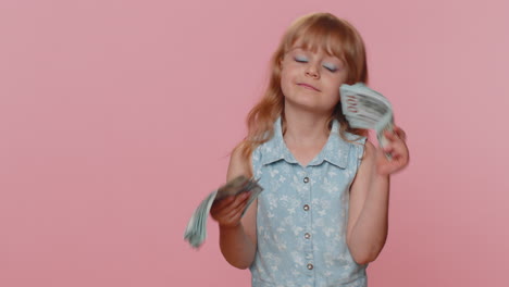 Successful-rich-child-girl-kid-holding-money-cash-dancing-listening-music-lottery-game-win-income