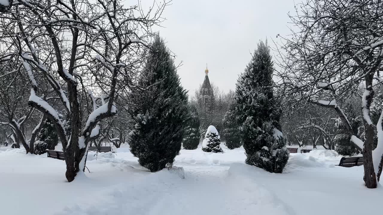It's snowing near the church on Christmas Day
