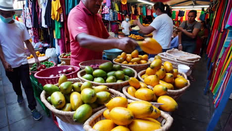 busy street market with fruit and clothing