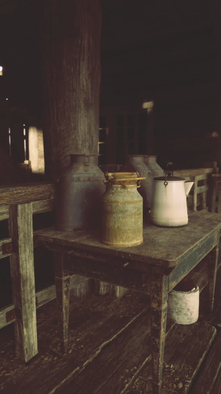 Rustic interior of an old barn showcasing vintage jars and wooden tables