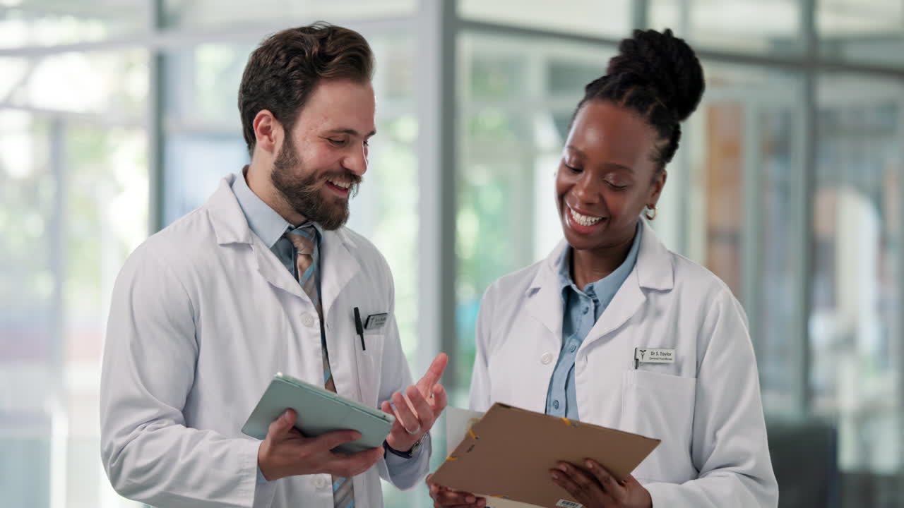 Diverse Medical Professionals Discussing Patient Information with Tablet and Clipboard