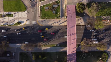 aerial top down shot of bus road and students passing law school bridge in buenos aires,argentina