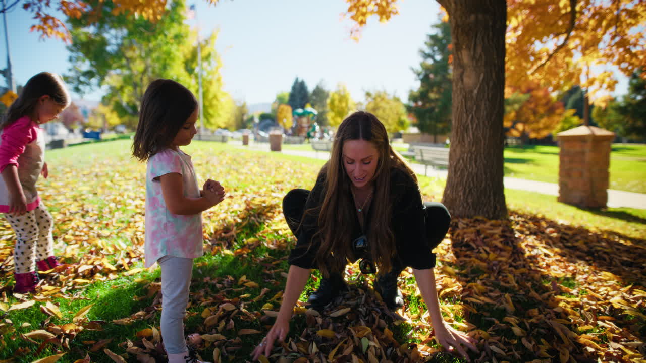 Happy Family Playing in Autumn Leaves
