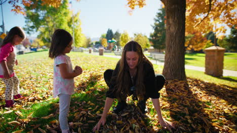 happy family playing in autumn leaves