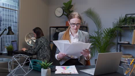 Displeased-upset-businesswoman-accountant-throwing-documents-after-analyzing-financial-office-papers