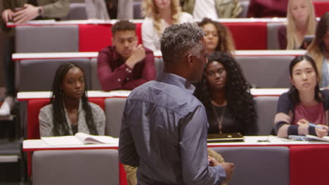 back view of male teacher lecturing university students, shot on r3d