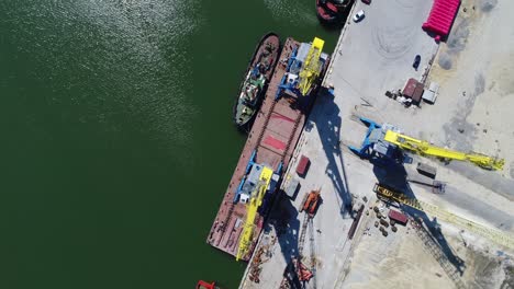 aerial view of a port with cargo ship and cranes