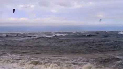 kite boarder sailing high in wind and ocean surf