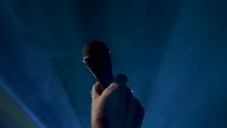 Microphone-rises-into-a-shot-on-a-smokey-background