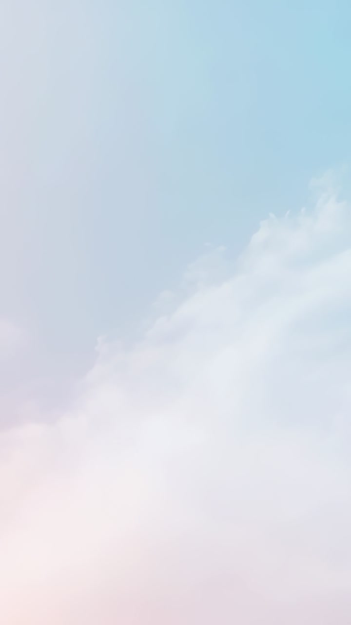Vertical video: Drifting pastel sky with wispy clouds shifting up at horizon, triggered by breeze