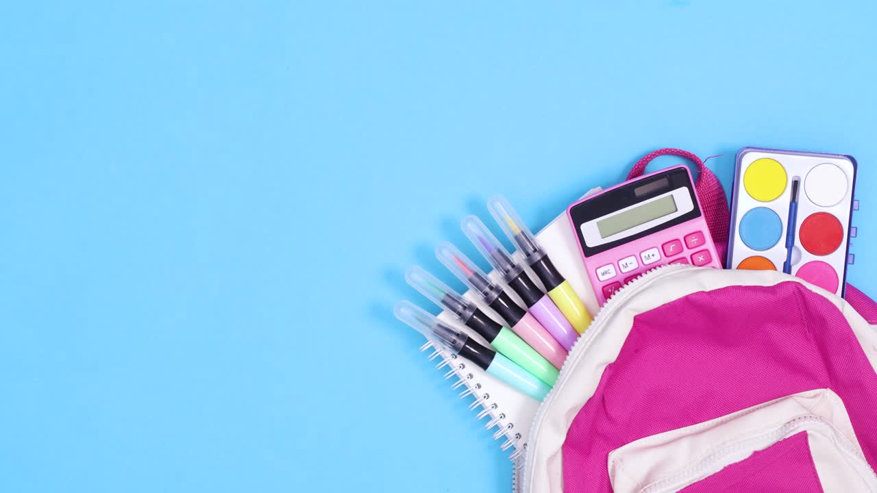 mochila escolar con papelería escolar se mueve y el papel para el texto aparece en fondo azul. detener el movimiento