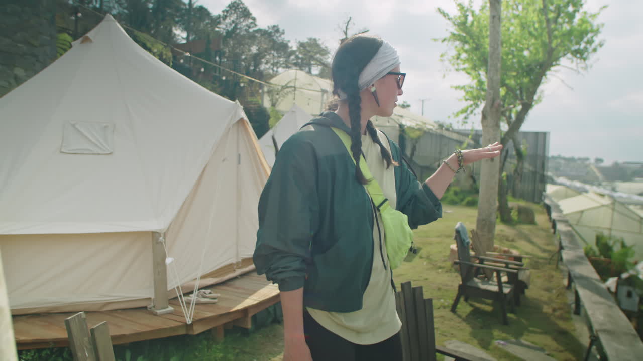 Two Female Tourists Walking through Glamping and Discussing View