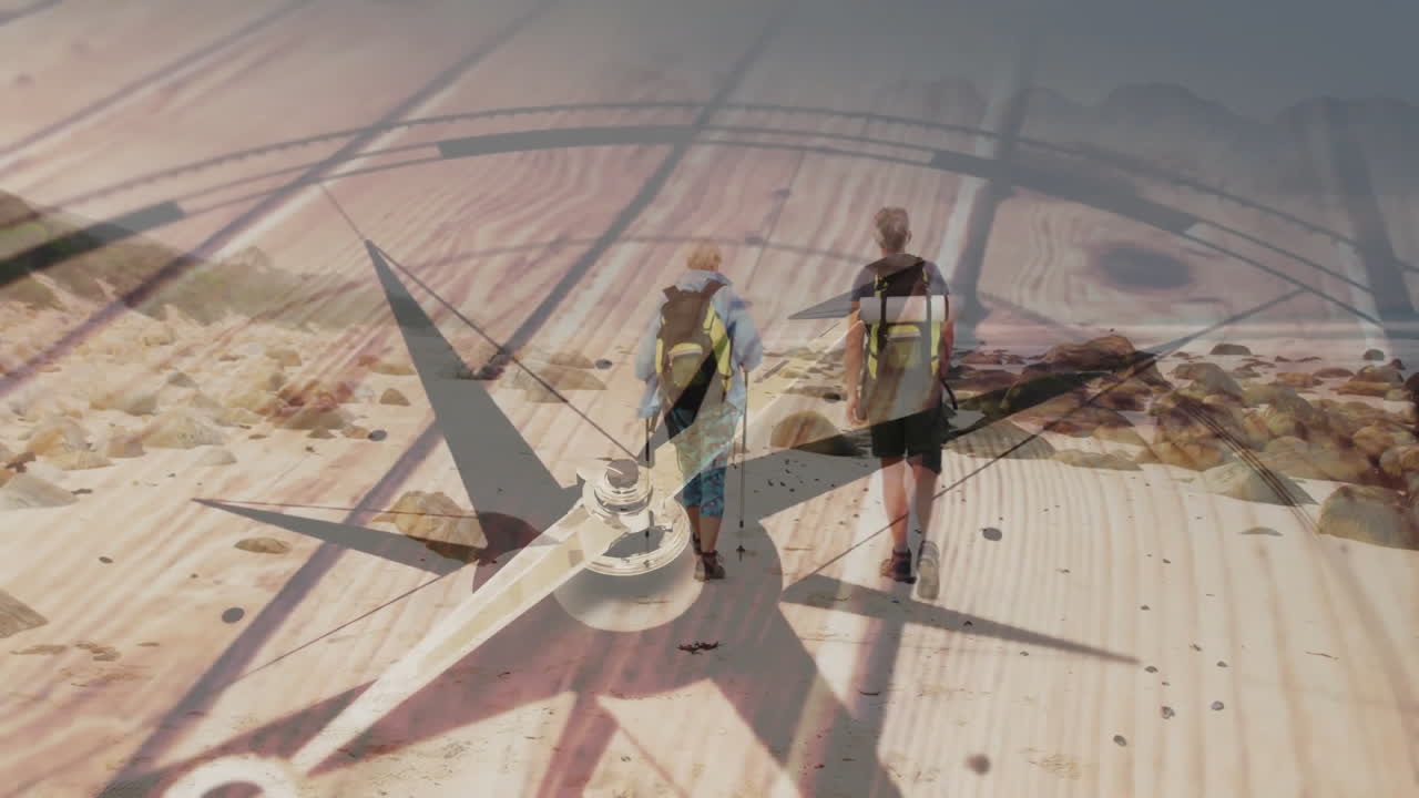 Two hikers walking across terrain, showing compass rose animation over planks for navigation tech