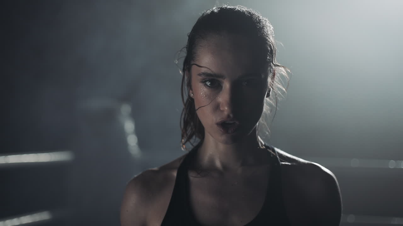 Intense Portrait of a Sweating Female Boxer
